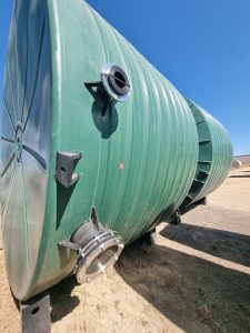 Large green water tank with fittings