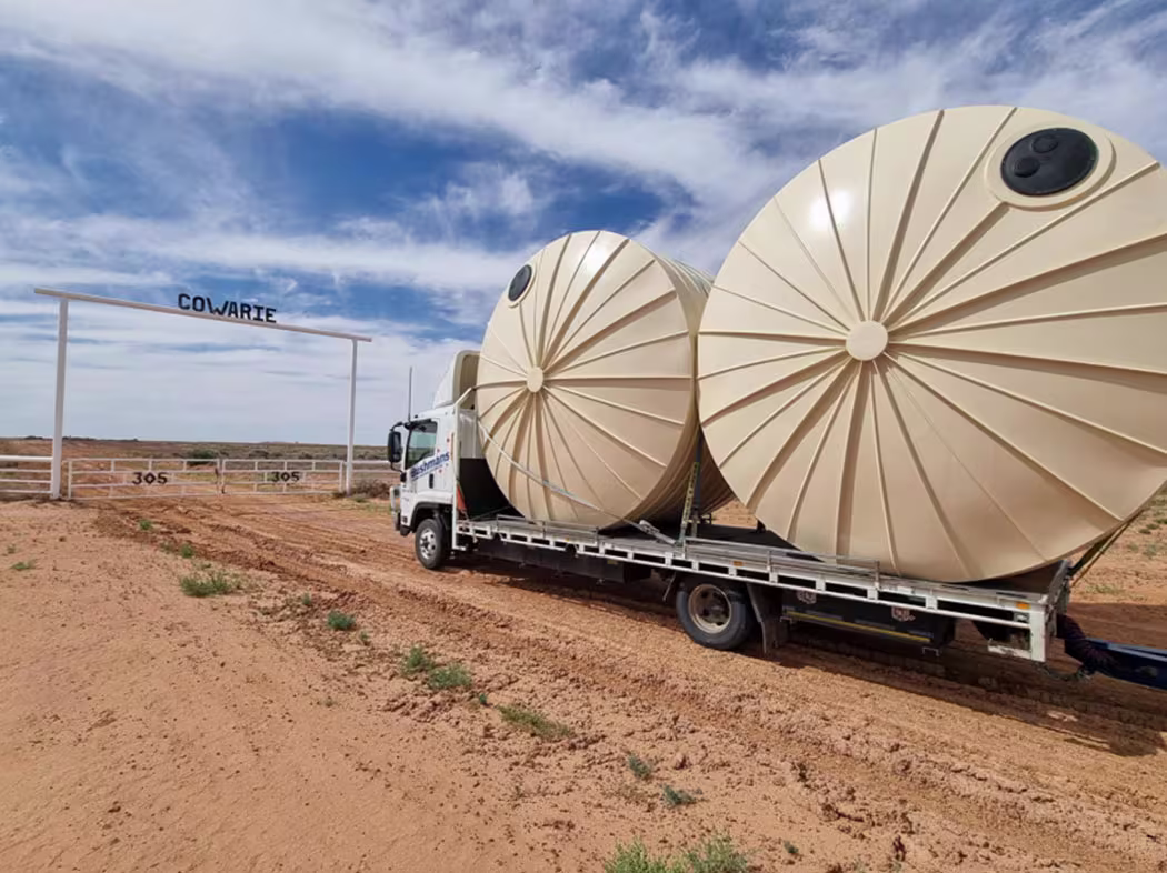 A freight truck carrying two high capacity water tanks